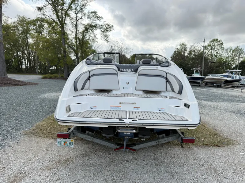 Slide: The Image of 2020 Yamaha Boats SX240 on trailer, rear view, parked outdoors. - 4
