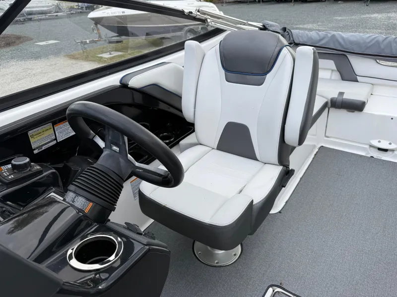 Slide: The Image of 2020 Yamaha Boats SX240 interior with sleek captain's chair and modern dashboard. - 7
