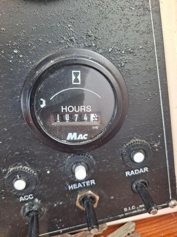 Slide: The Image of Hour meter on 2000 Osprey 26 Fisherman boat dashboard, showing 1074.8 hours. - 5