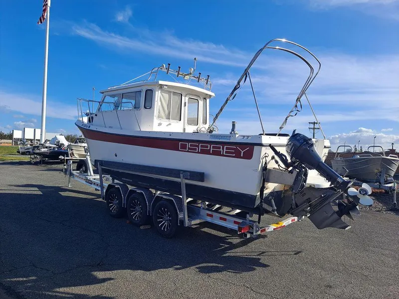 Slide: The Image of 2000 Osprey 26 Fisherman boat on trailer under clear blue sky. - 9