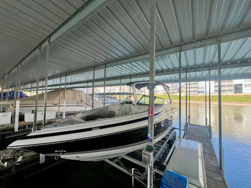 Slide: The Image of 2018 Crownline 285 SS boat docked in a covered marina. - 1