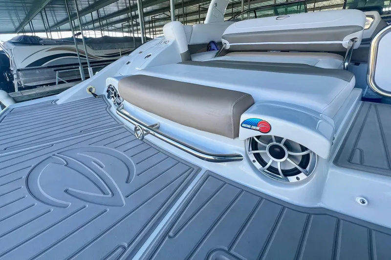 Slide: The Image of 2018 Crownline 285 SS boat with cushioned seating and speaker on deck. - 10