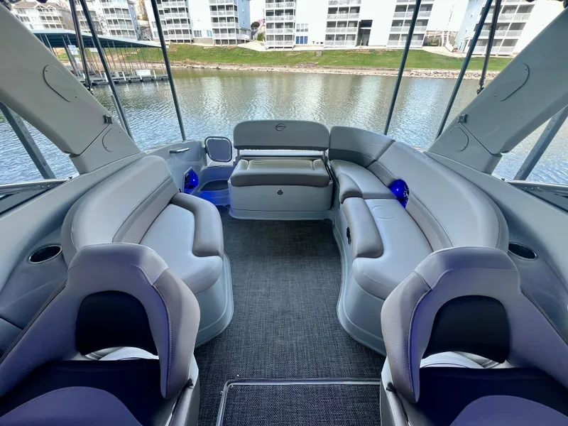 Slide: The Image of 2018 Crownline 285 SS boat interior with luxurious seating and waterfront view. - 12