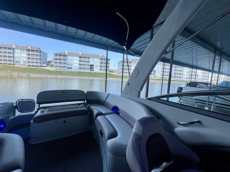 Slide: The Image of Interior view of 2018 Crownline 285 SS boat with waterfront backdrop. - 16
