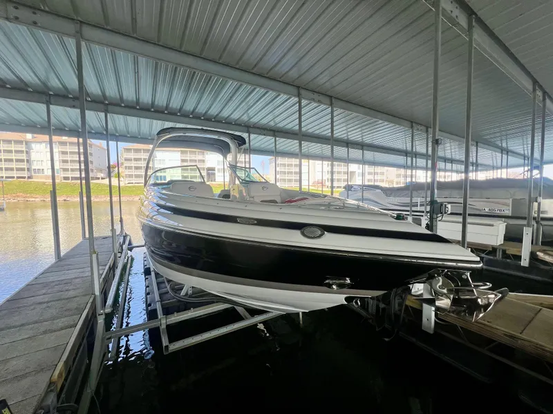 Slide: The Image of 2018 Crownline 285 SS boat docked in a covered marina. - 2