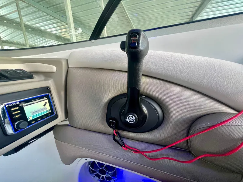 Slide: The Image of Interior of 2018 Crownline 285 SS boat with control lever and audio system. - 21