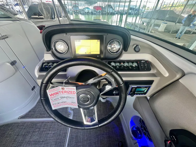 Slide: The Image of 2018 Crownline 285 SS boat dashboard with steering wheel and control panel. - 22