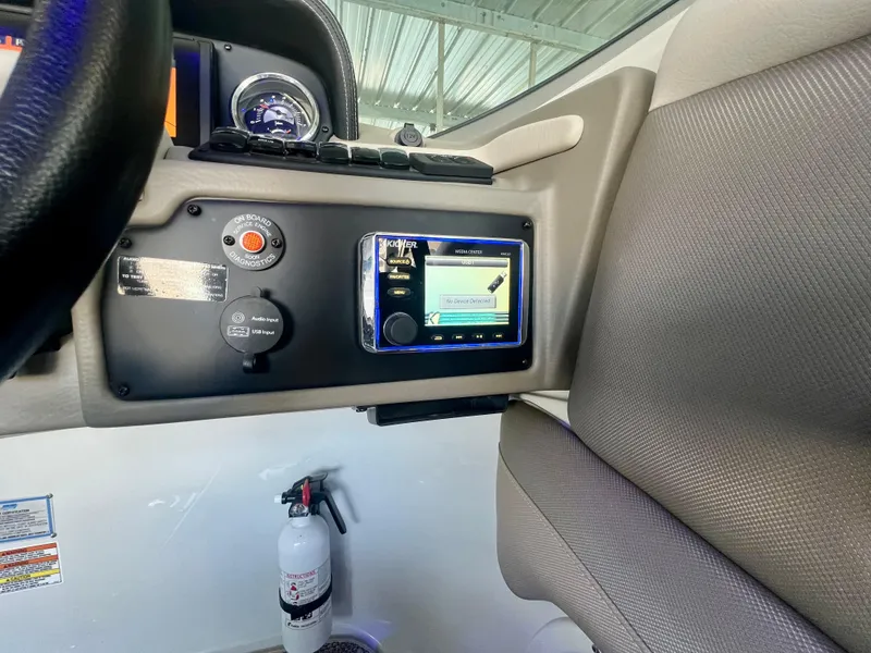 Slide: The Image of Control panel of a 2018 Crownline 285 SS boat with a fire extinguisher below. - 23