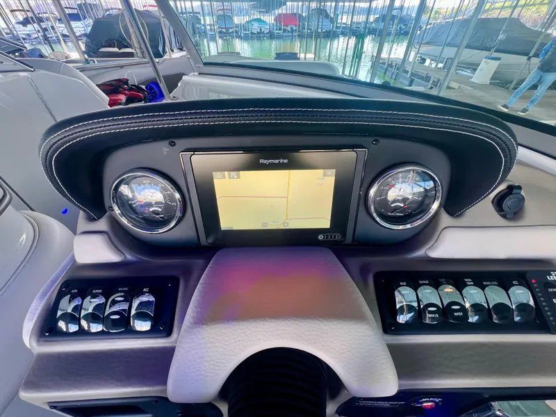 Slide: The Image of Dashboard of 2018 Crownline 285 SS boat with navigation system and controls. - 24