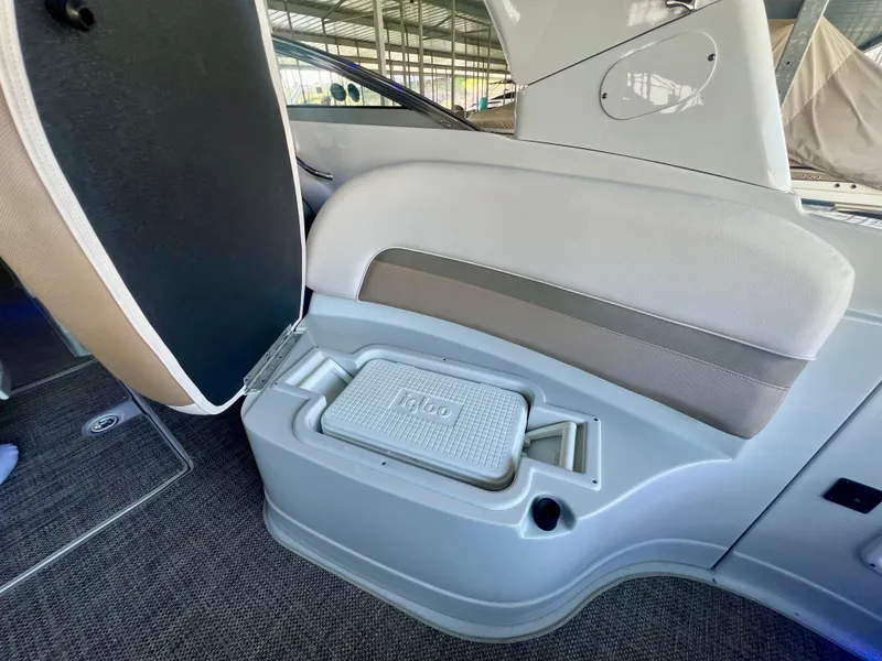 Slide: The Image of 2018 Crownline 285 SS boat interior with seating and built-in cooler. - 27