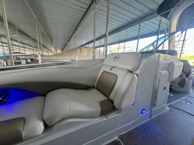 Slide: The Image of 2018 Crownline 285 SS boat interior with luxurious seating and ambient lighting. - 31