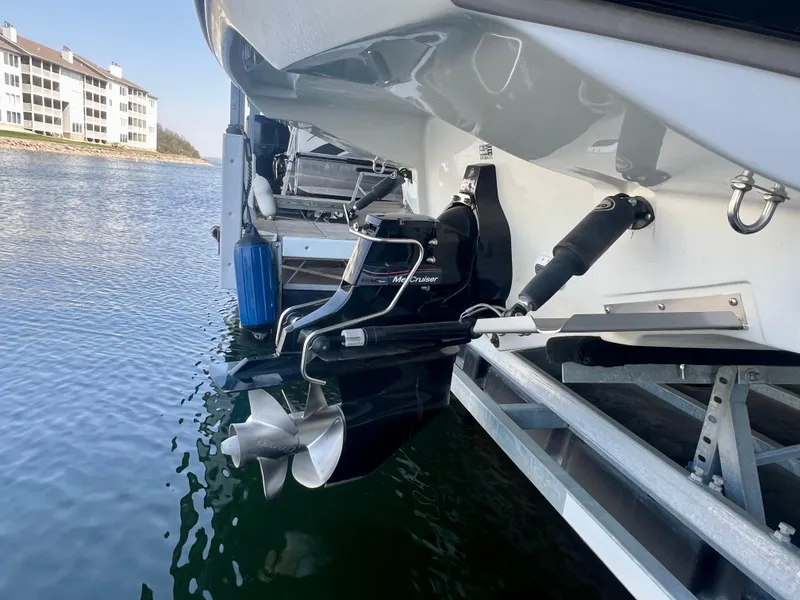 Slide: The Image of 2018 Crownline 285 SS boat with outboard motor, docked near waterfront buildings. - 34