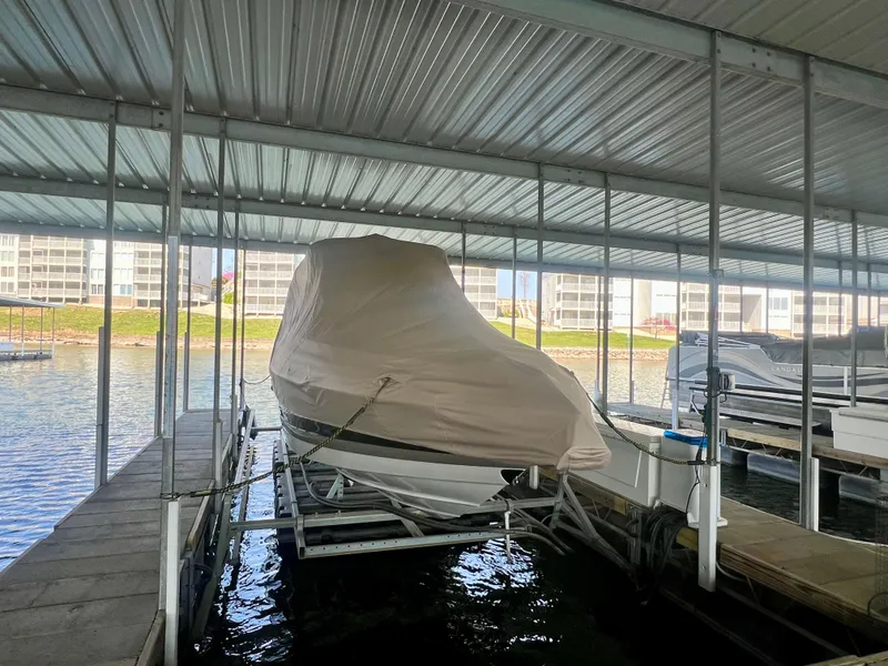 Slide: The Image of Covered 2018 Crownline 285 SS boat docked in a marina. - 37