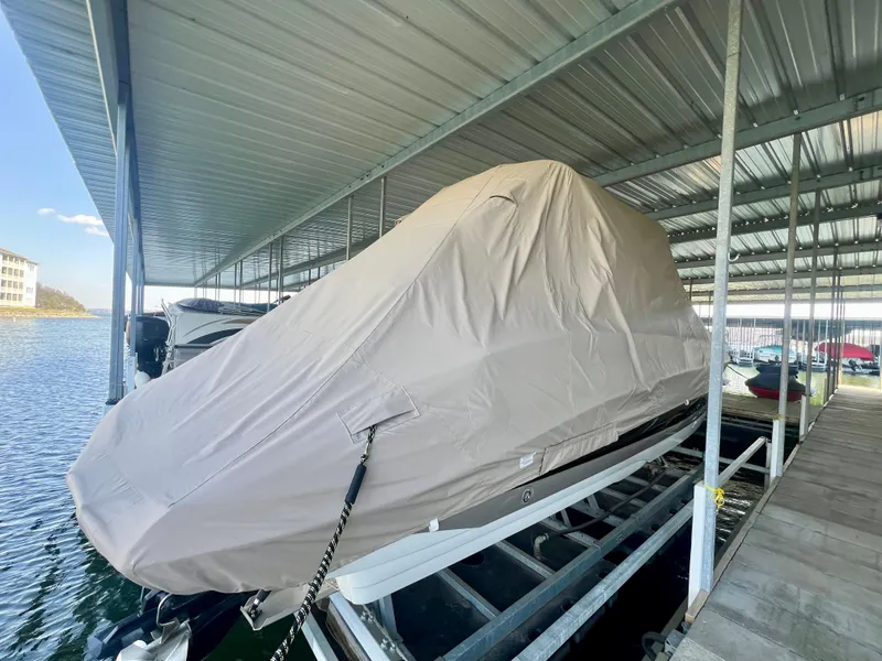 Slide: The Image of Covered 2018 Crownline 285 SS boat docked under a metal canopy. - 38