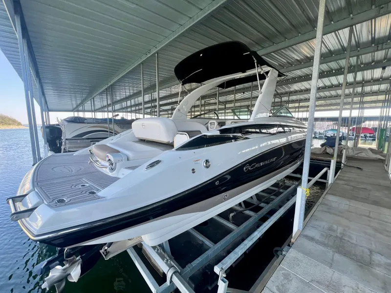 Slide: The Image of 2018 Crownline 285 SS boat docked under a covered marina. - 5