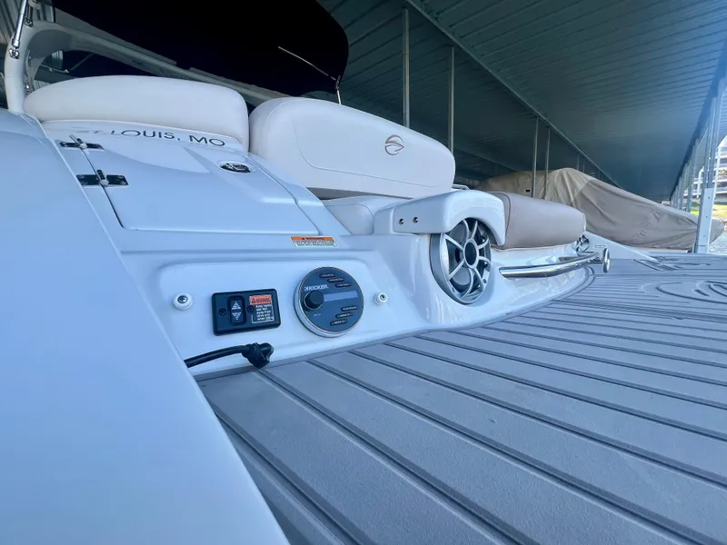 Slide: The Image of 2018 Crownline 285 SS boat interior with seating and audio controls. - 7