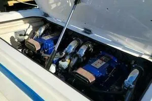 Slide: The Image of Twin blue engines in a 2002 Profile 33 V boat, under an open hatch. - 13