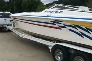 Slide: The Image of 2002 Profile 33 V speedboat on trailer with colorful graphics. - 4