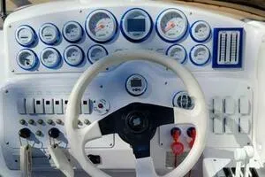 Slide: The Image of Control panel of a 2002 Profile 33 V boat with gauges and steering wheel. - 6