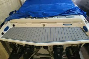 Slide: The Image of 2002 Profile 33 V boat with blue cover and visible outboard motors. - 7