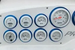 Slide: The Image of Dashboard gauges of a 2002 Profile 33 V boat, featuring multiple dials and indicators. - 8