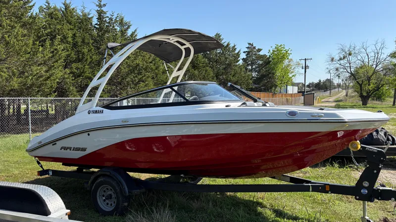 Slide: The Image of 2024 Yamaha AR195 boat with sleek design on a trailer, parked outdoors. - 12