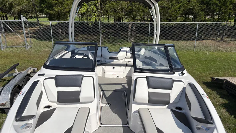 Slide: The Image of 2024 Yamaha Boats AR195, rear view, on trailer, in outdoor setting. - 16