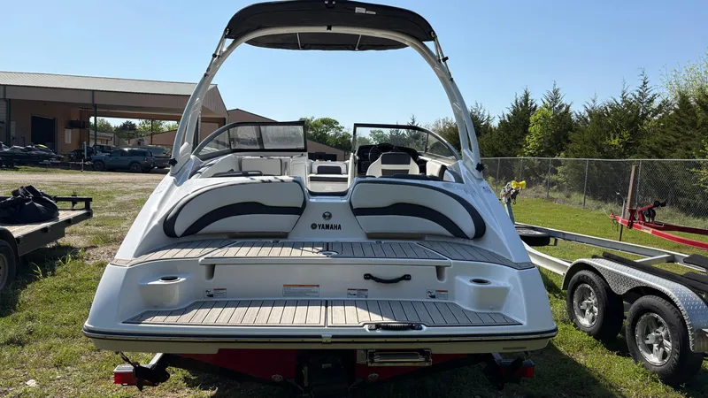 Slide: The Image of 2024 Yamaha AR195 boat rear view with swim platform and ladder. - 17
