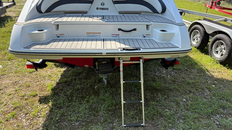 Slide: The Image of 2024 Yamaha Boats AR195 rear view showing jet drive and hull details. - 18