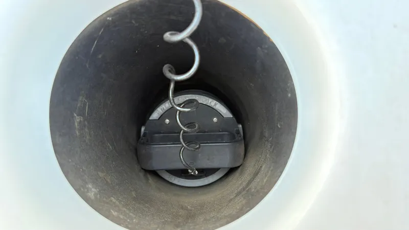 Slide: The Image of 2024 Yamaha Boats AR195 interior with seating and steering wheel, parked outdoors. - 22