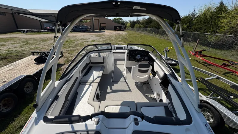 Slide: The Image of 2024 Yamaha Boats AR195 interior with spacious seating and modern dashboard. - 23