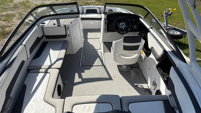 Slide: The Image of 2024 Yamaha Boats AR195 interior with steering wheel, seating, and open deck layout. - 24