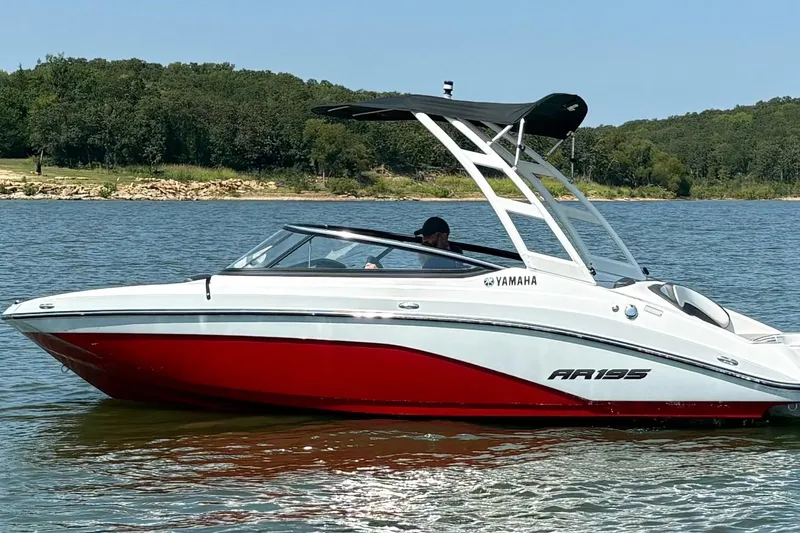 Slide: The Image of 2024 Yamaha Boats AR195 on a lake, featuring sleek design and vibrant red hull. - 5