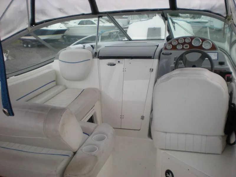 Slide: The Image of 2006 Bayliner 245 SB boat interior with seating and dashboard. - 2