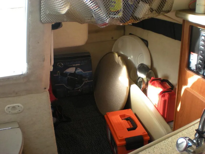 Slide: The Image of Interior of 2006 Bayliner 245 SB boat with storage items and equipment. - 4