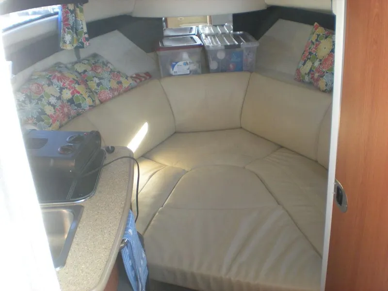 Slide: The Image of Interior of 2006 Bayliner 245 SB boat with cozy seating and floral cushions. - 6