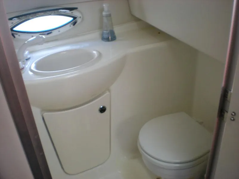 Slide: The Image of Compact bathroom in 2006 Bayliner 245 SB boat with sink and toilet. - 7