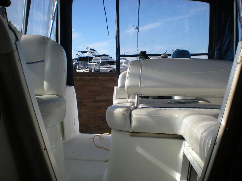 Slide: The Image of Interior view of a 2006 Bayliner 245 SB boat with white seating. - 8