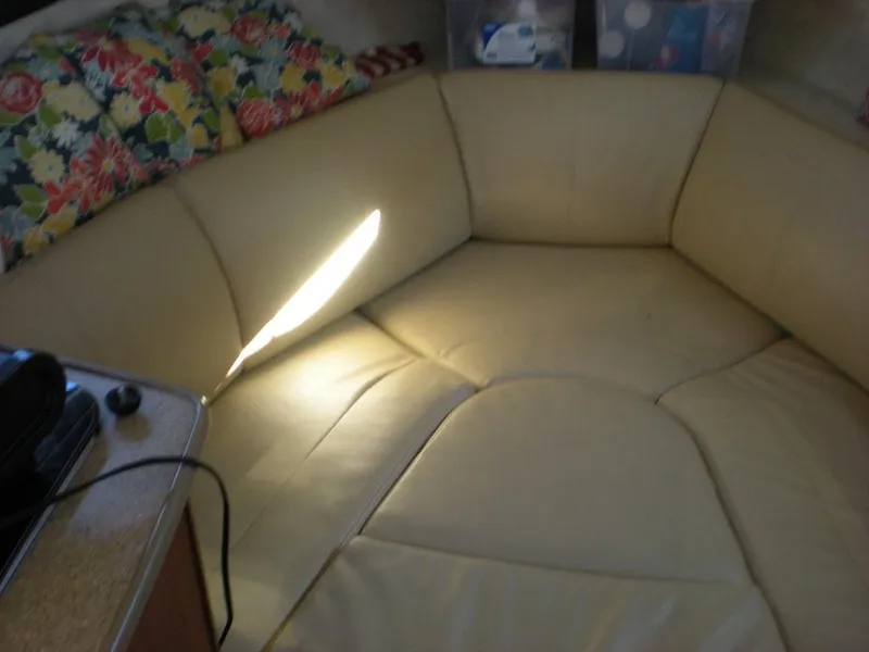 Slide: The Image of Interior seating area of a 2006 Bayliner 245 SB boat with floral cushions. - 9
