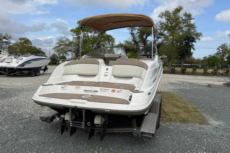 Slide: The Image of 2008 Yamaha Boats 232 Limited on trailer, featuring a beige canopy and dual engines. - 12