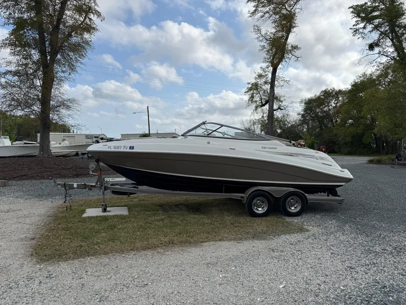 Slide: The Image of 2008 Yamaha Boats 232 Limited on trailer, parked outdoors under cloudy sky. - 3