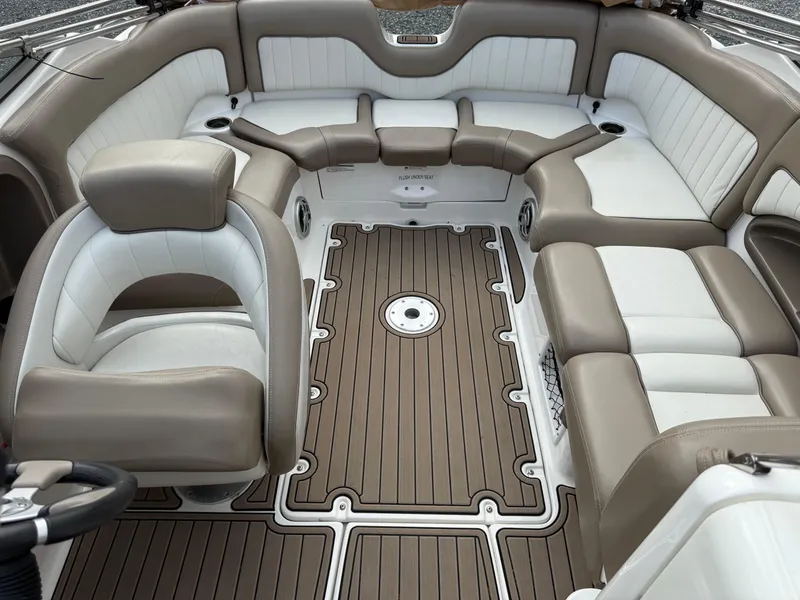 Slide: The Image of 2008 Yamaha Boats 232 Limited interior with beige and white seating, brown flooring. - 8