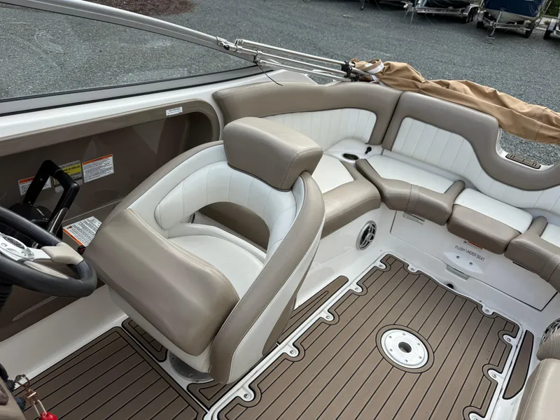 Slide: The Image of 2008 Yamaha Boats 232 Limited interior with beige and white seating, wood-style flooring. - 9