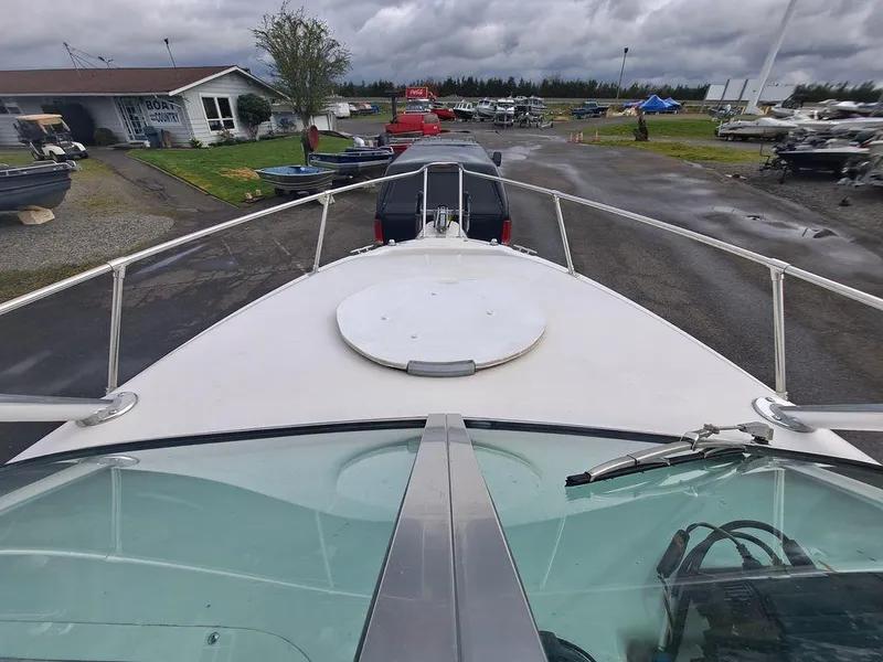 Slide: The Image of 2000 Seaswirl 2501 boat on trailer at a marina, cloudy sky background. - 9