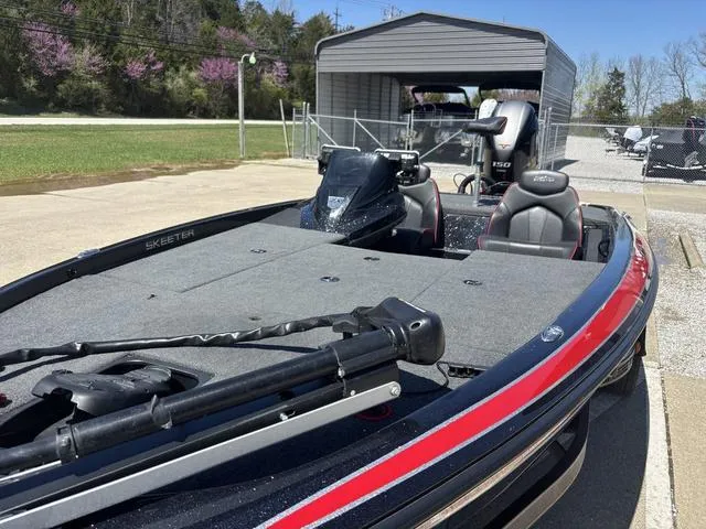 Slide: The Image of 2022 Skeeter ZX150 boat with spacious deck and modern design in outdoor setting. - 10
