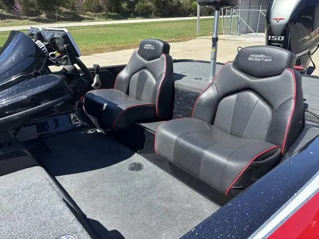 Slide: The Image of 2022 Skeeter ZX150 boat interior with black and red seats. - 11