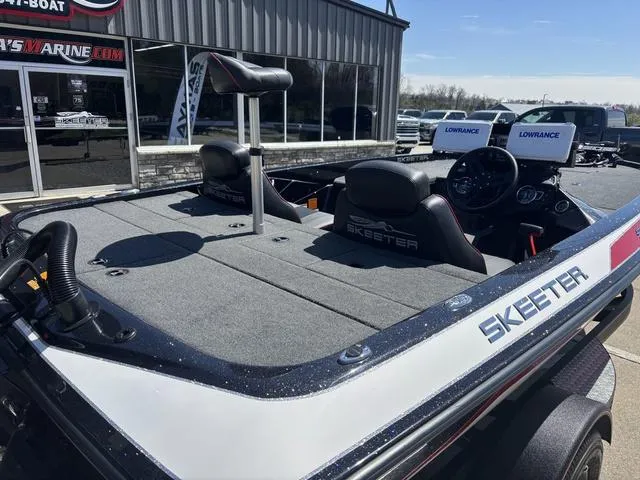 Slide: The Image of 2022 Skeeter ZX150 boat with Lowrance electronics, parked outside a marine dealership. - 3