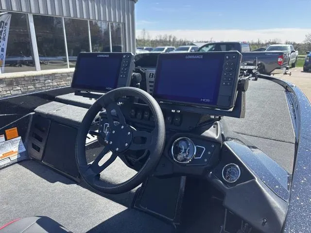 Slide: The Image of 2022 Skeeter ZX150 boat dashboard with dual Lowrance displays and steering wheel. - 5