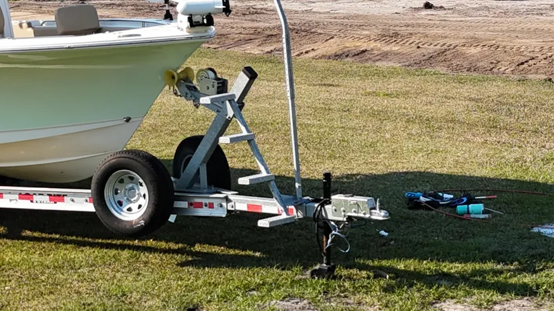 Slide: The Image of 2018 Sea Hunt Ultra 235 SE boat on trailer, parked on grass. - 11