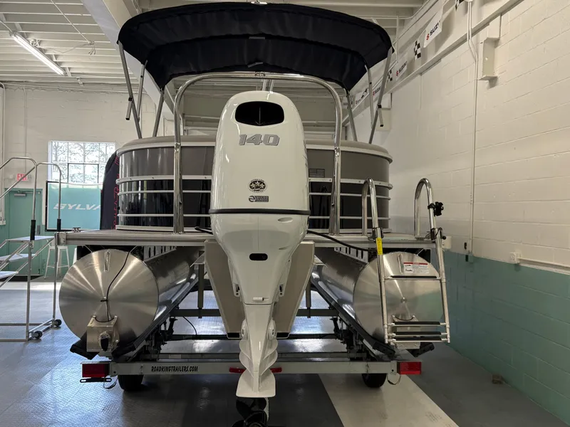 Slide: The Image of 2025 South Bay 222RS pontoon boat with outboard motor in a showroom. - 3